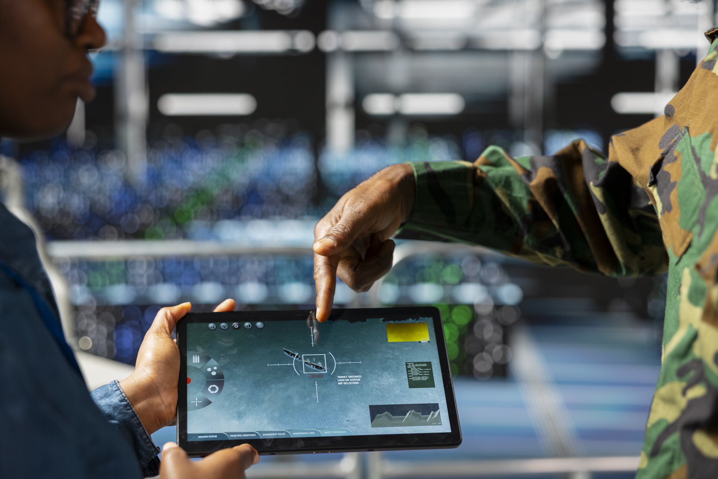Operator reviewing tactical data on a tablet
